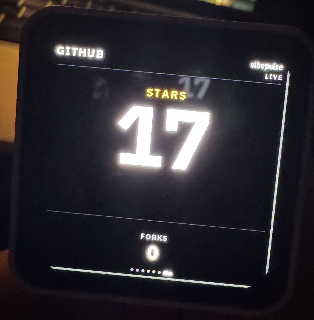 The GitHub tile photographed on the real AMOLED panel, showing 17 stars
