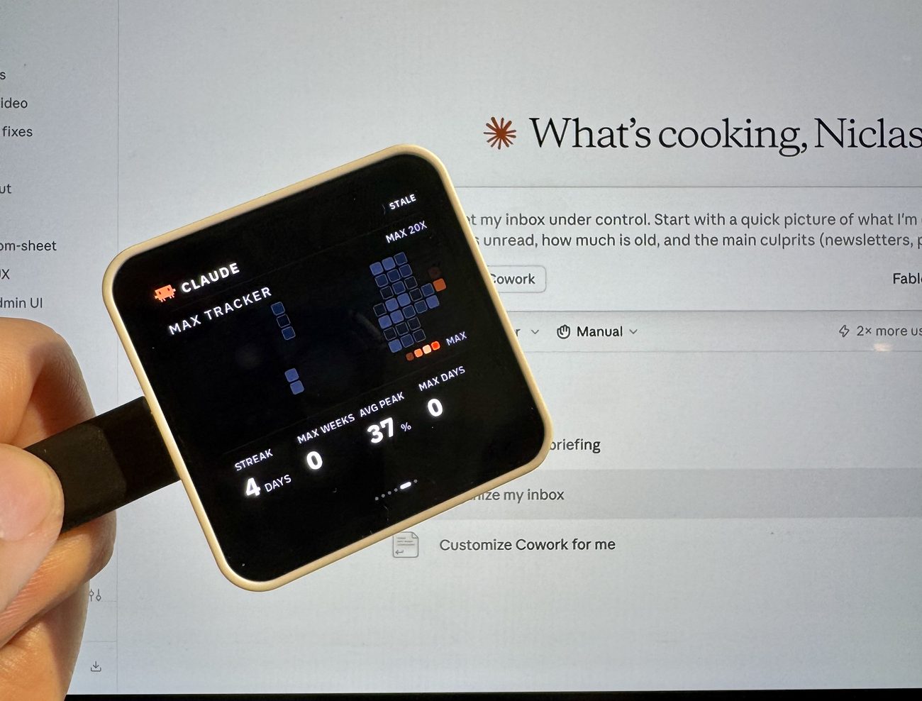 The panel held in a hand showing Claude's Max Tracker heatmap