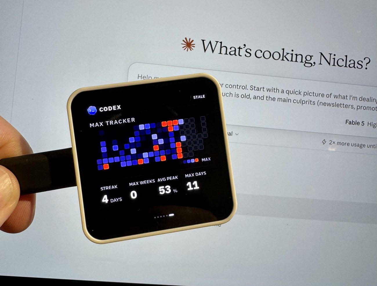 The panel held in a hand showing Codex's Max Tracker heatmap