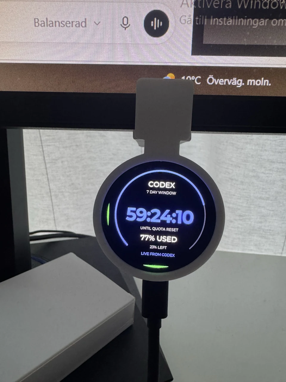 Round Codex display showing 59 hours, 24 minutes and 10 seconds until quota reset, with 77 percent used and 23 percent left